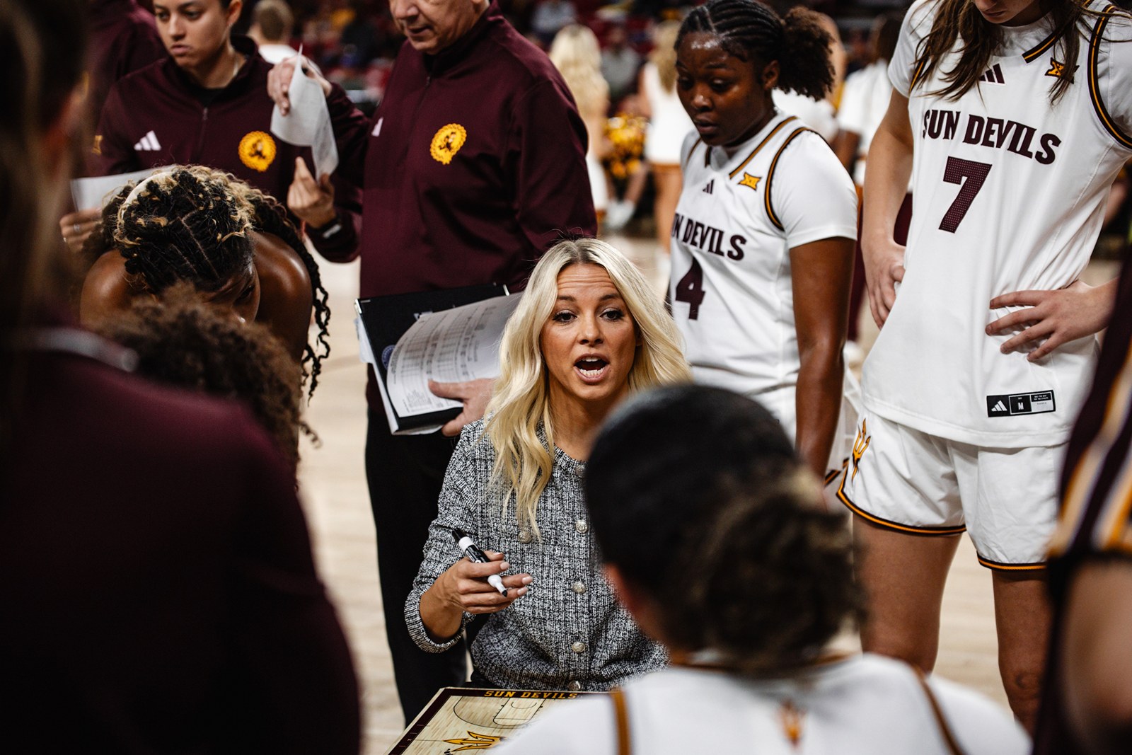 Molly Miller coaching in an ASU team huddle